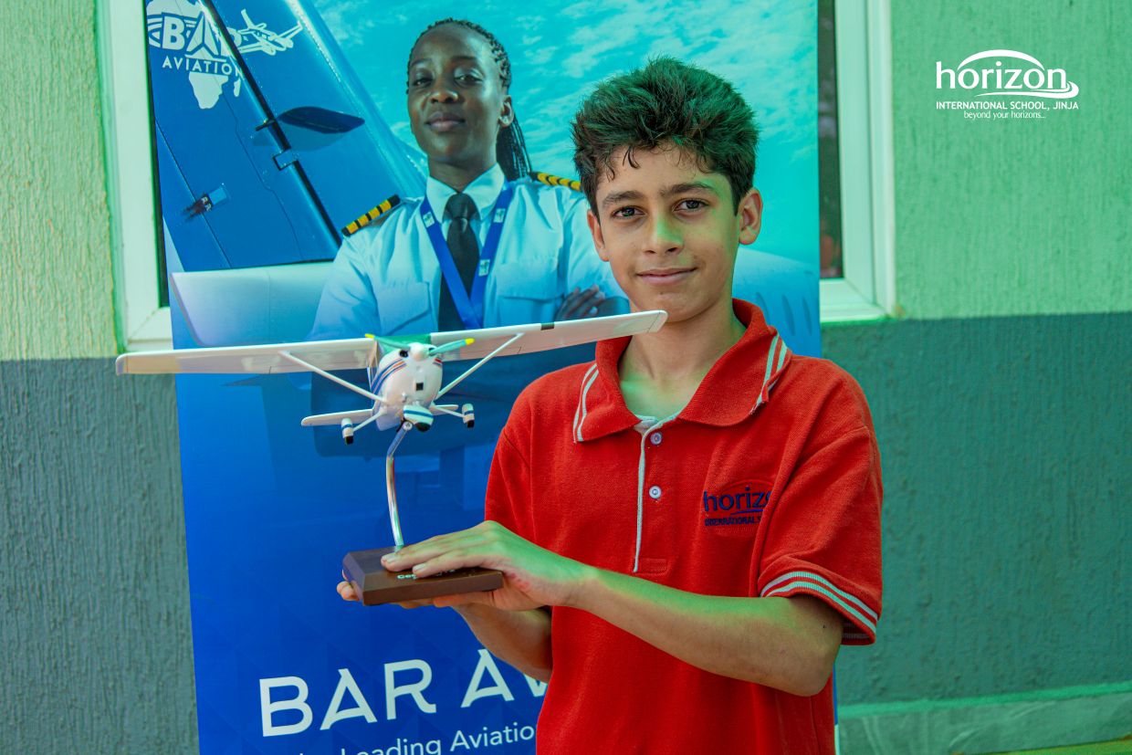 Horizon student presenting an aviation model at a university fair table